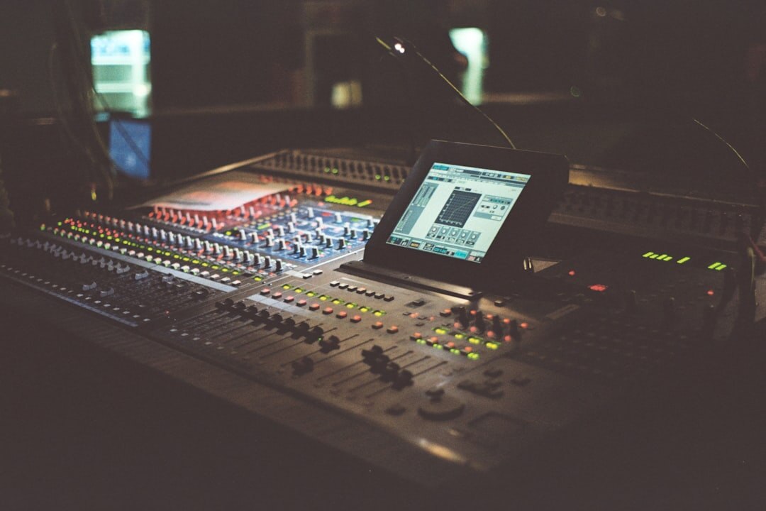Broadcast control room with multiple video monitors and a switching console